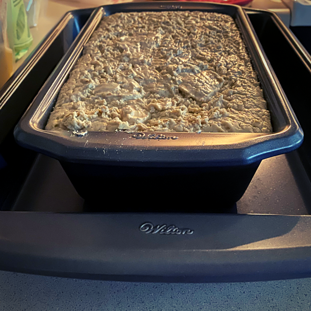 millet flour sourdough bread in container raised